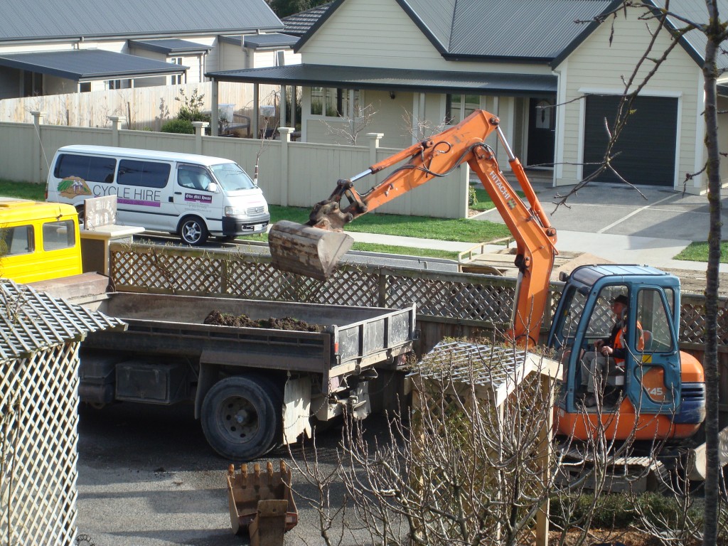 Digger Clearing Old Driveway