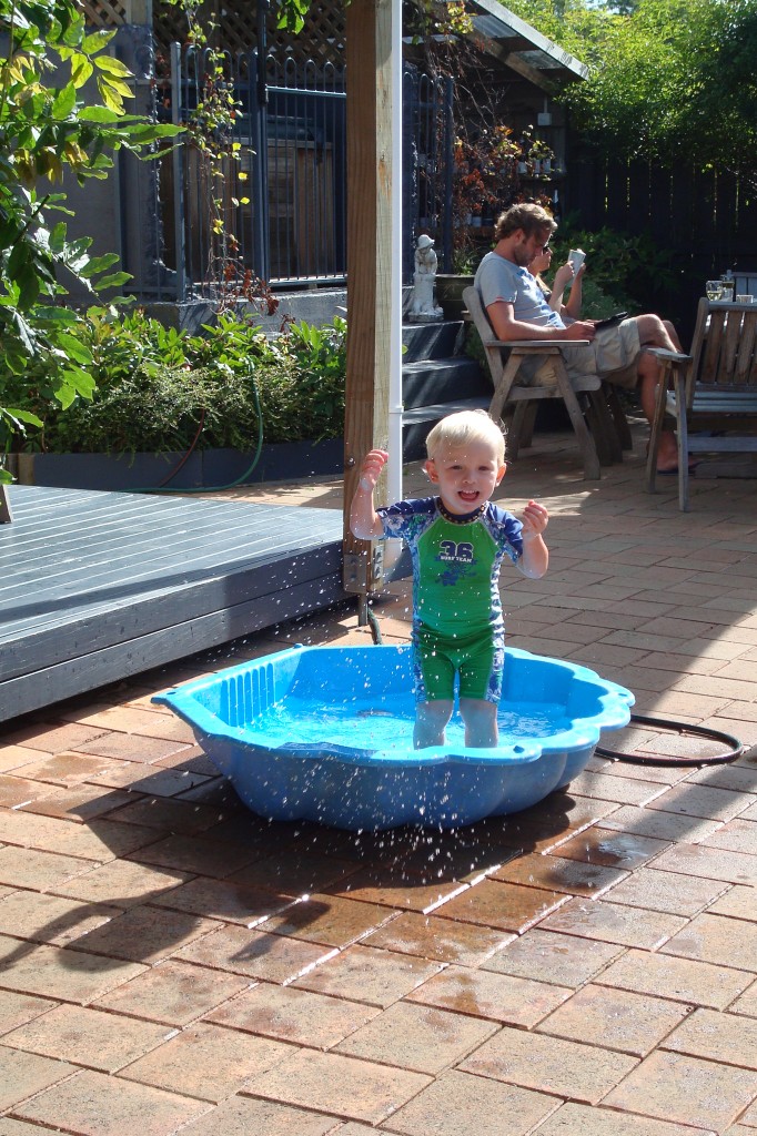 Toby playing in clam paddling pool
